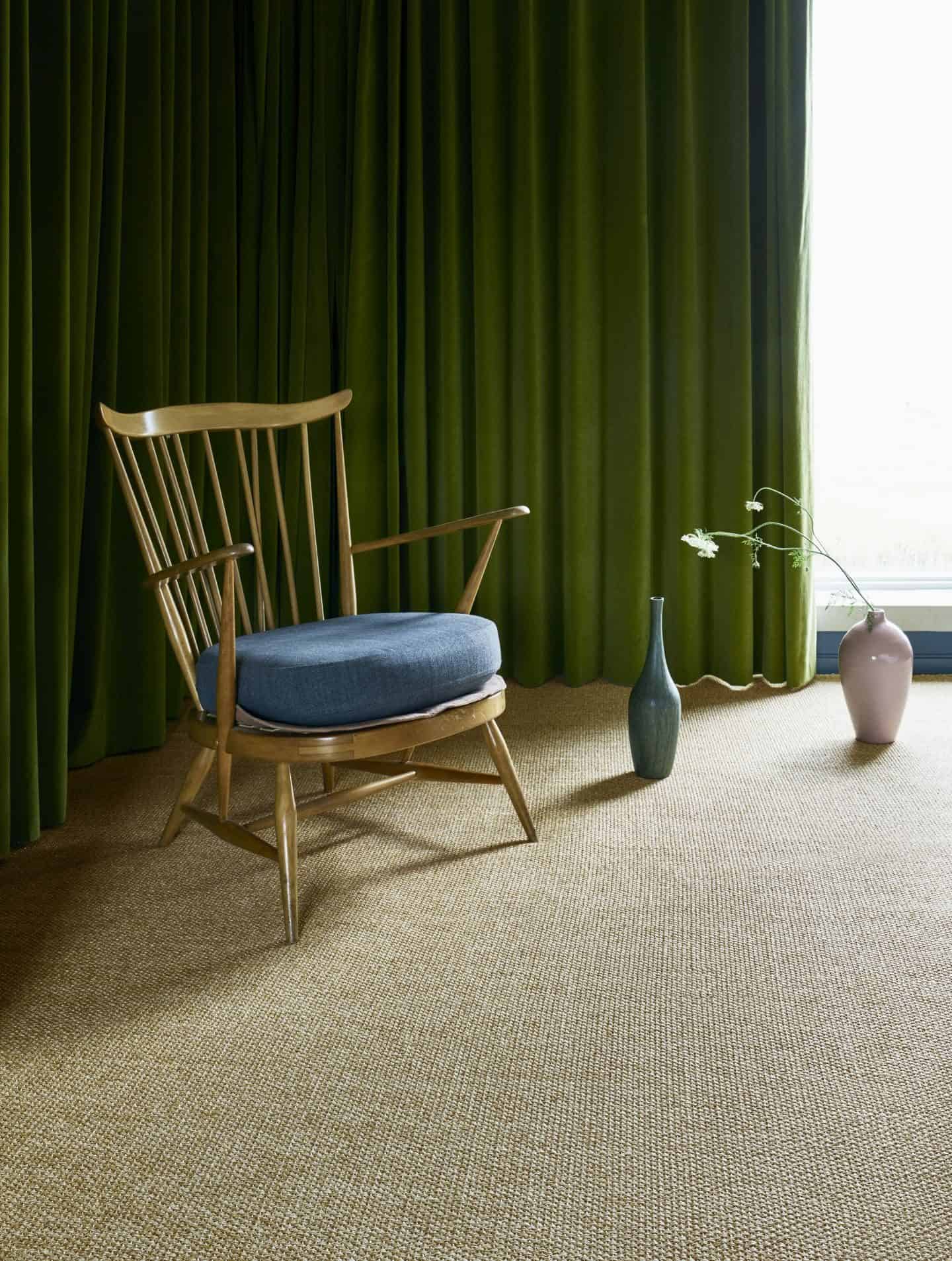 A wooden chair on sisal carpet by Kersaint Cobb in Panama, Oatmeal.