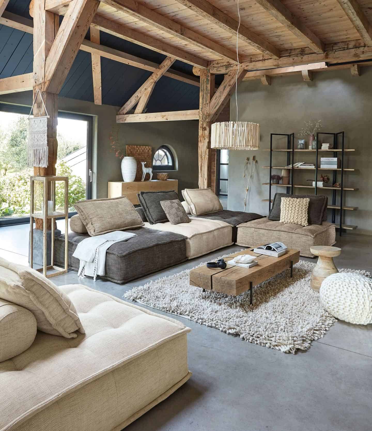 A living room decorated in neutral earthy colour palette using lots of natural materials and strong textures. 