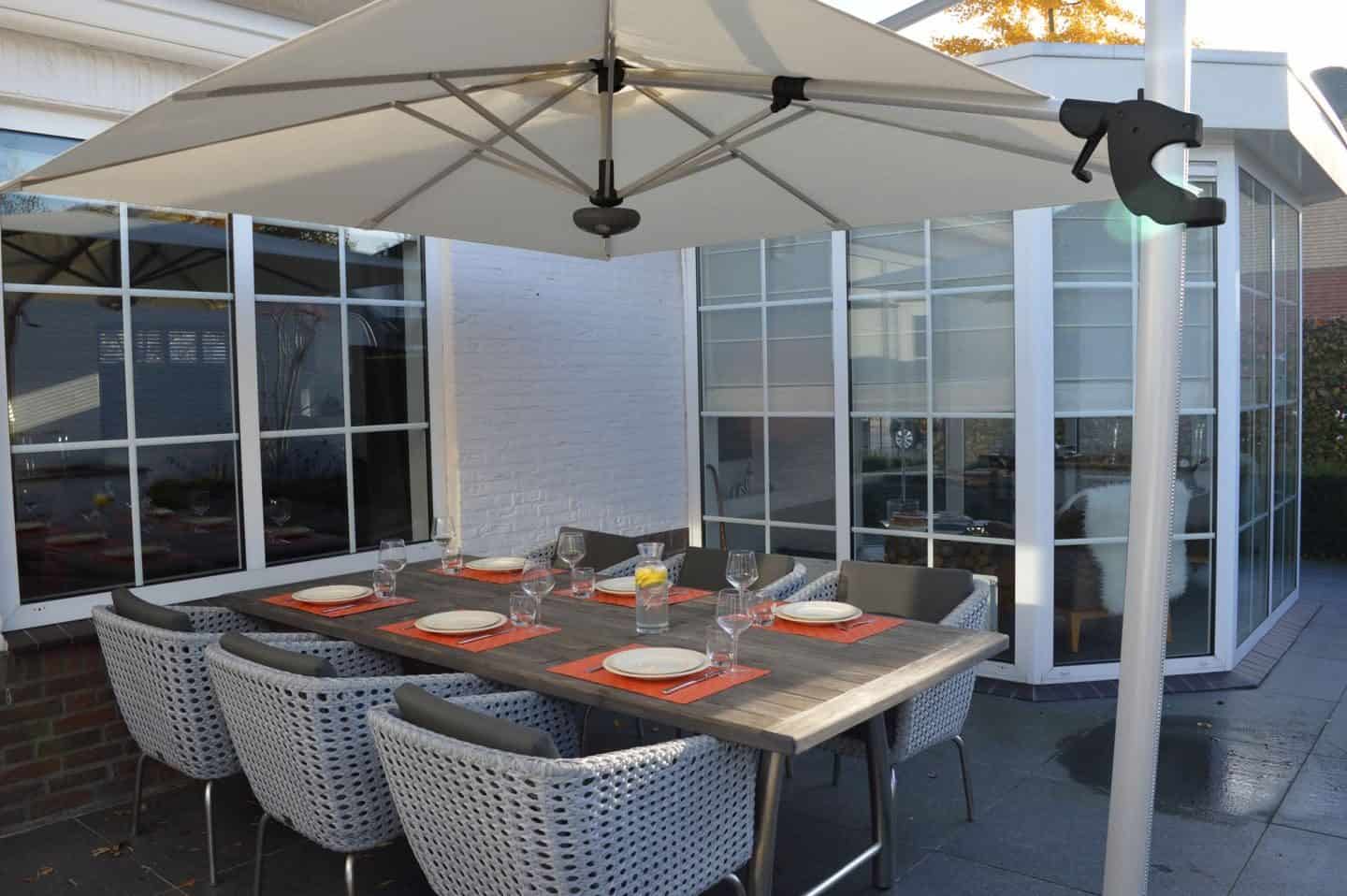 Garden Parasol from Solero Parasols.  Large square cantilvered parasol above an outdoor dining set.  