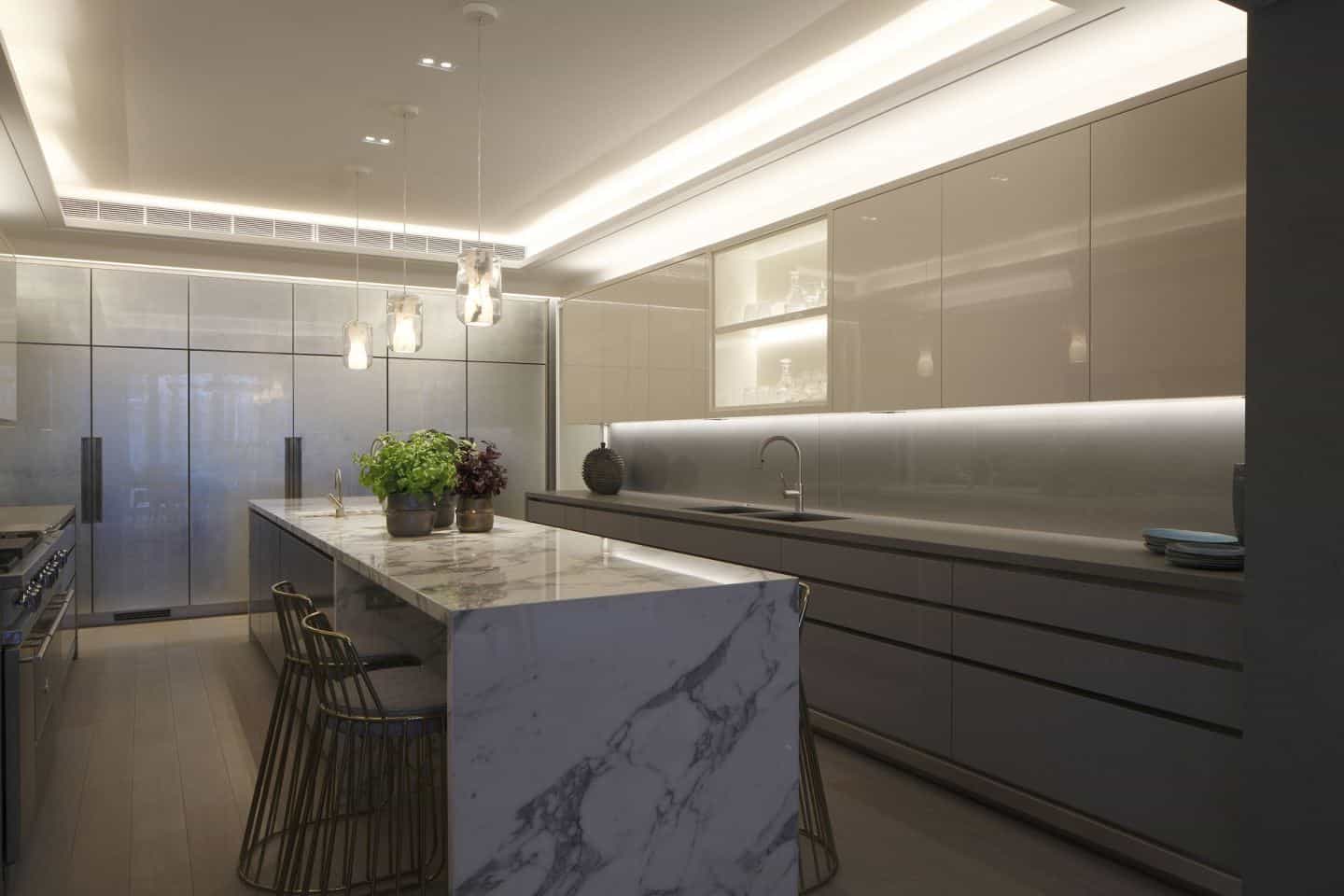 recessed downlighting illuminates a marble kitchen by John Cullen