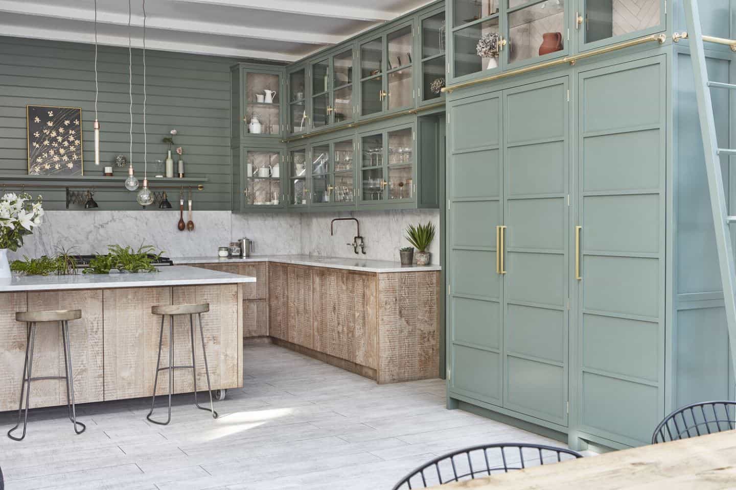 Urban rustic kitchen design features raw wood lower cabinets and mint green upper cabinets.