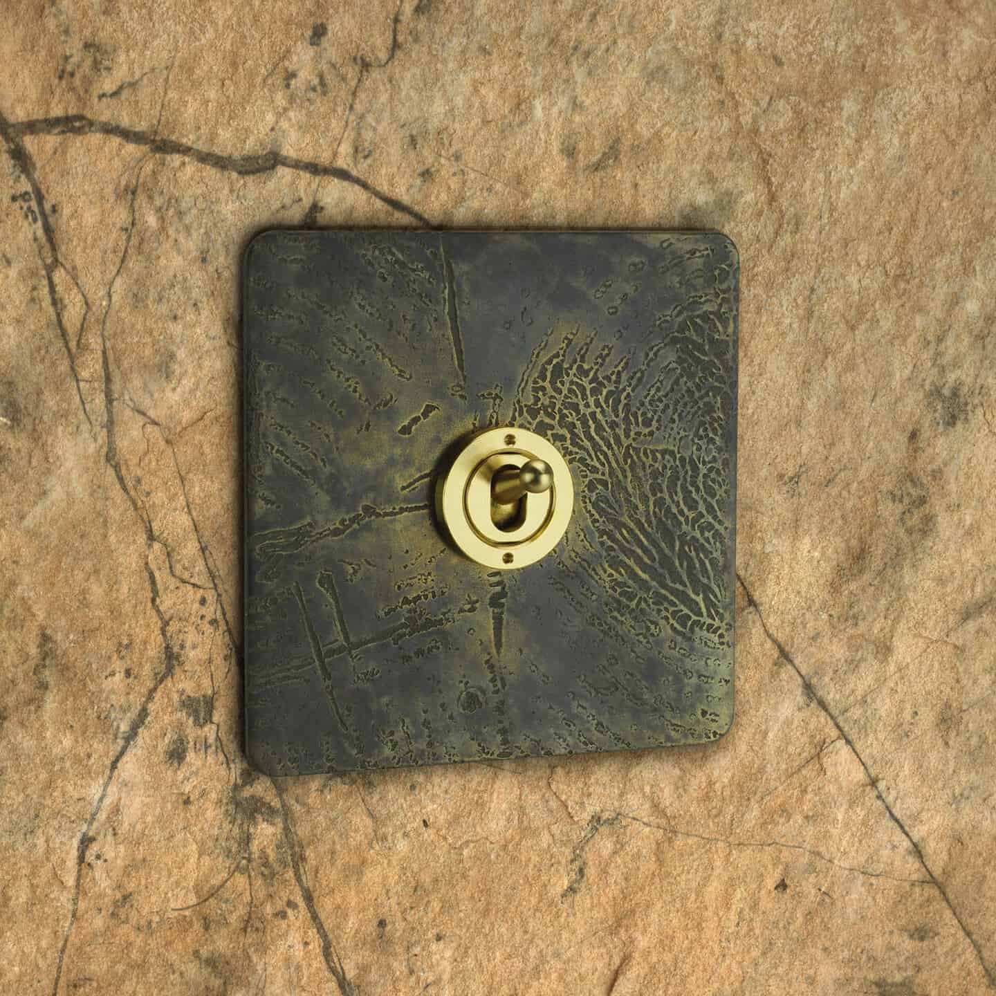 Focus SB Nature Inspired light switch. Aged Brass Plate featuring a tree bark texture.