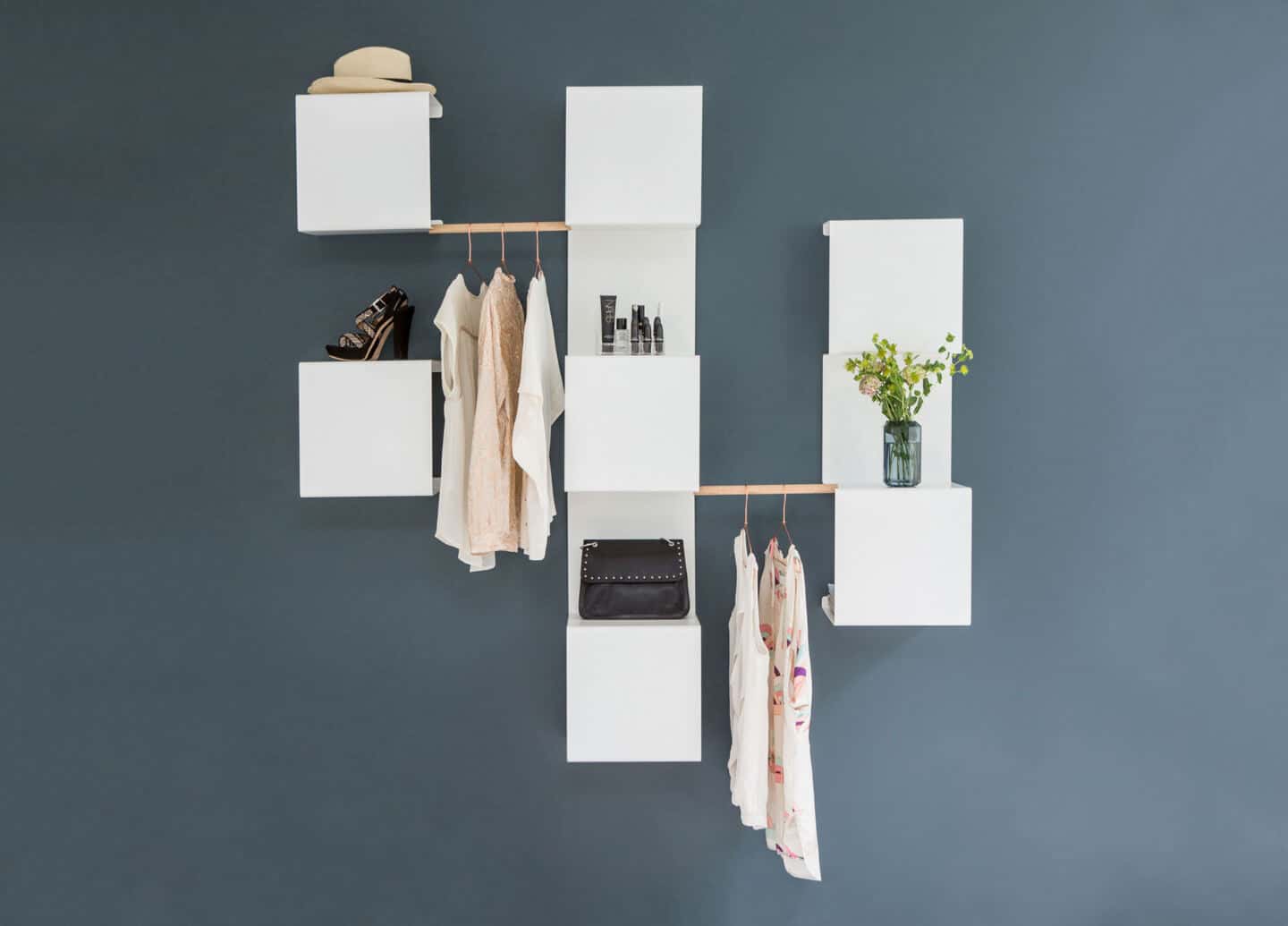 Sculptural and functional home storage solutions from Anne Linde. Bent sheet metal shelving provides a versatile wall hung unit ideal for use in a hallway.