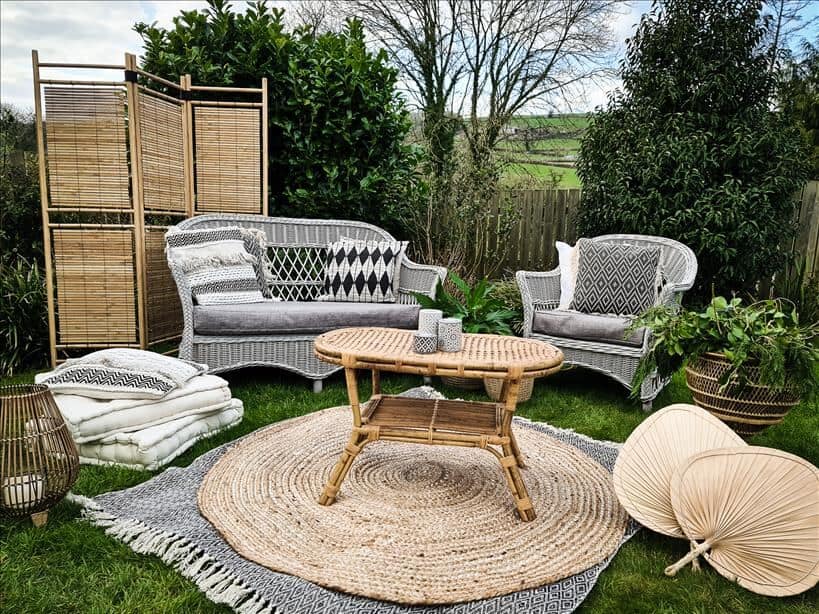 Entertain outdoors by setting up rattan furniture , rugs, a rattan table, floor cushions and a wooden screen