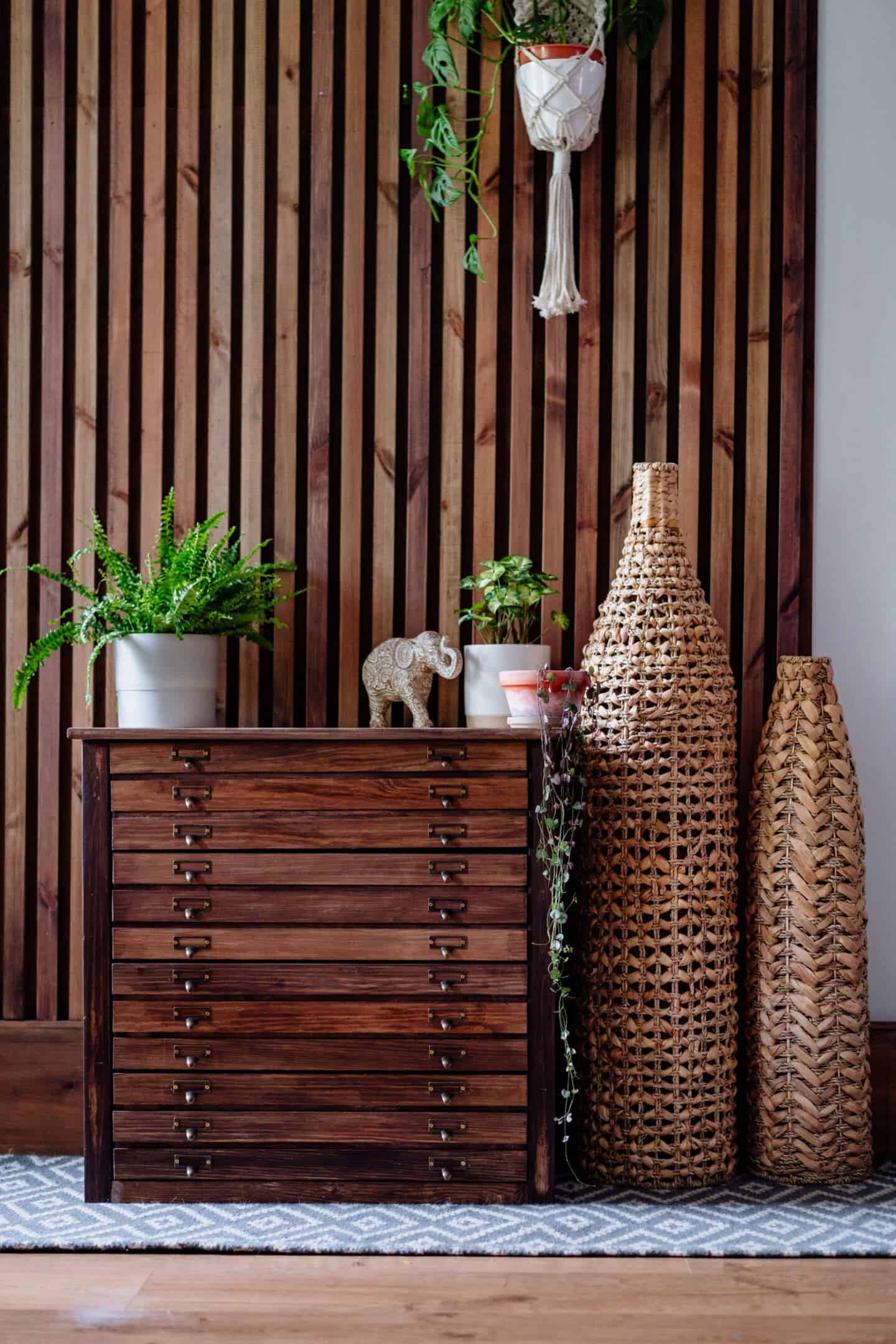 A living room with vertical slat wooden panelling 