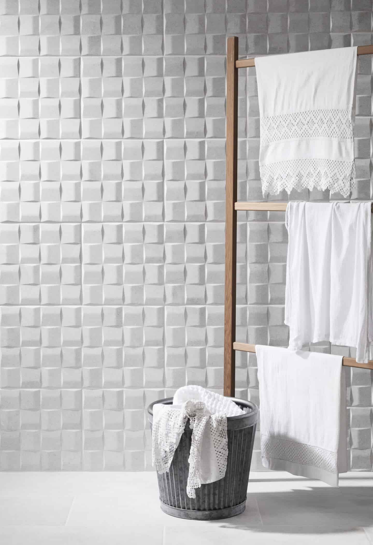 Textured walls featuring Polesden Art White Tile from CTD Tiles seen with a clothes dryer and laundry basket