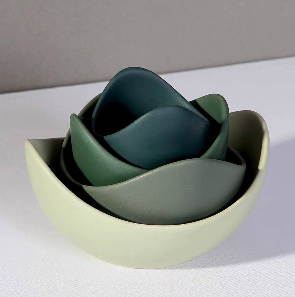 A stack of green ceramic bowls