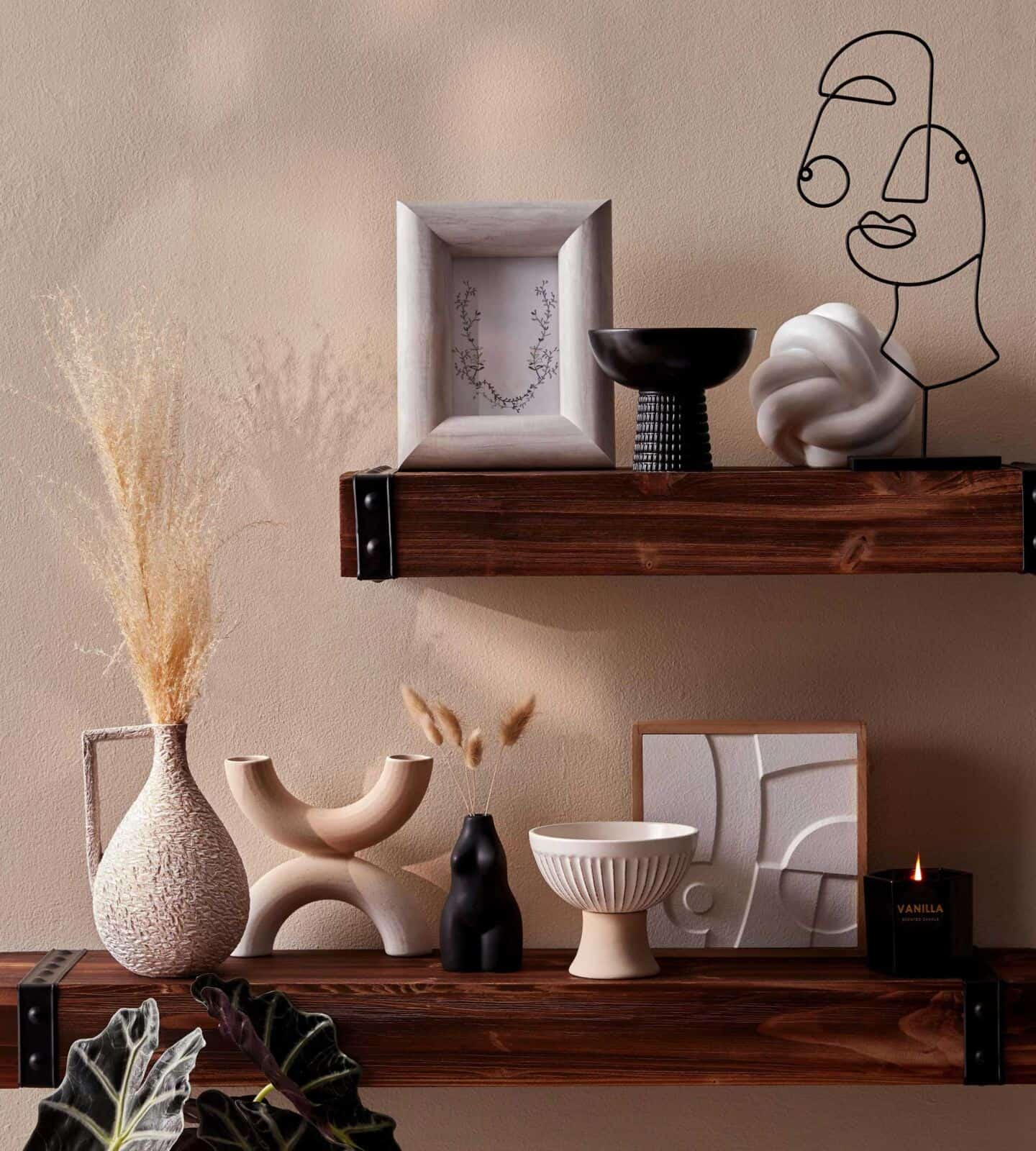 A selection of Primark Homeware pieces from the SS22 range arranged on two chunky wooden wall shelves 