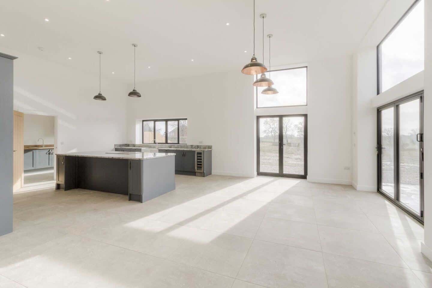 Aluminium doors and windows maximise the natural light in this large open-plan kitchen