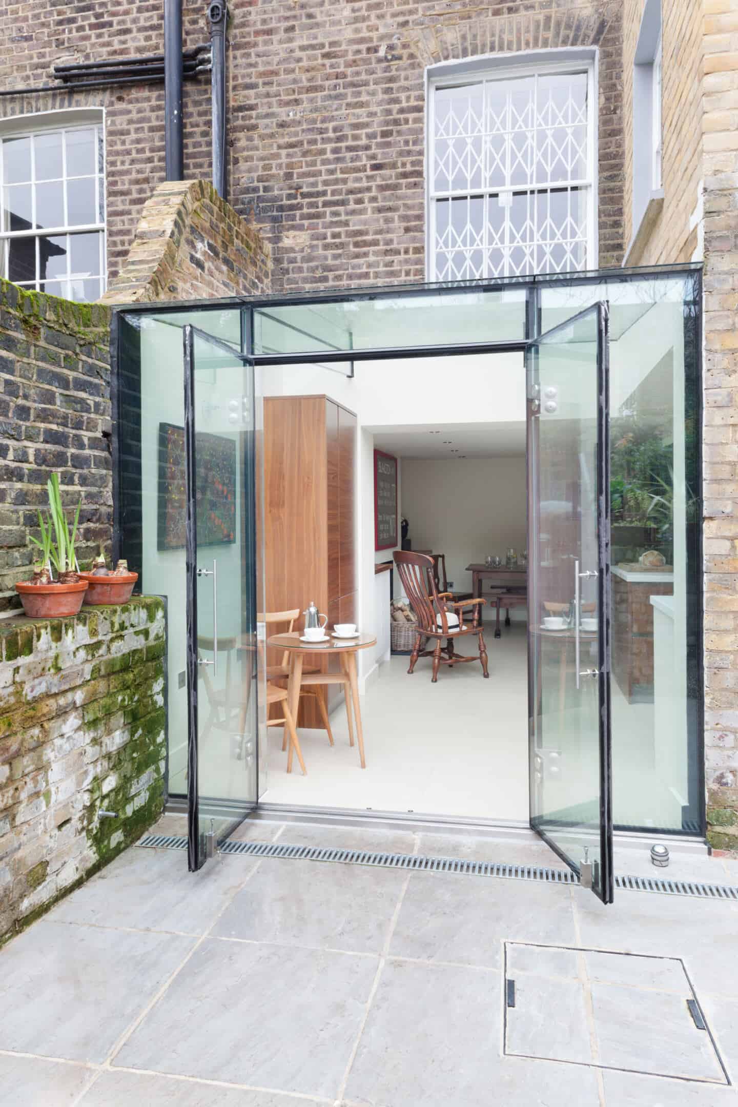 A glass box rear extension floods a kitchen with natural light