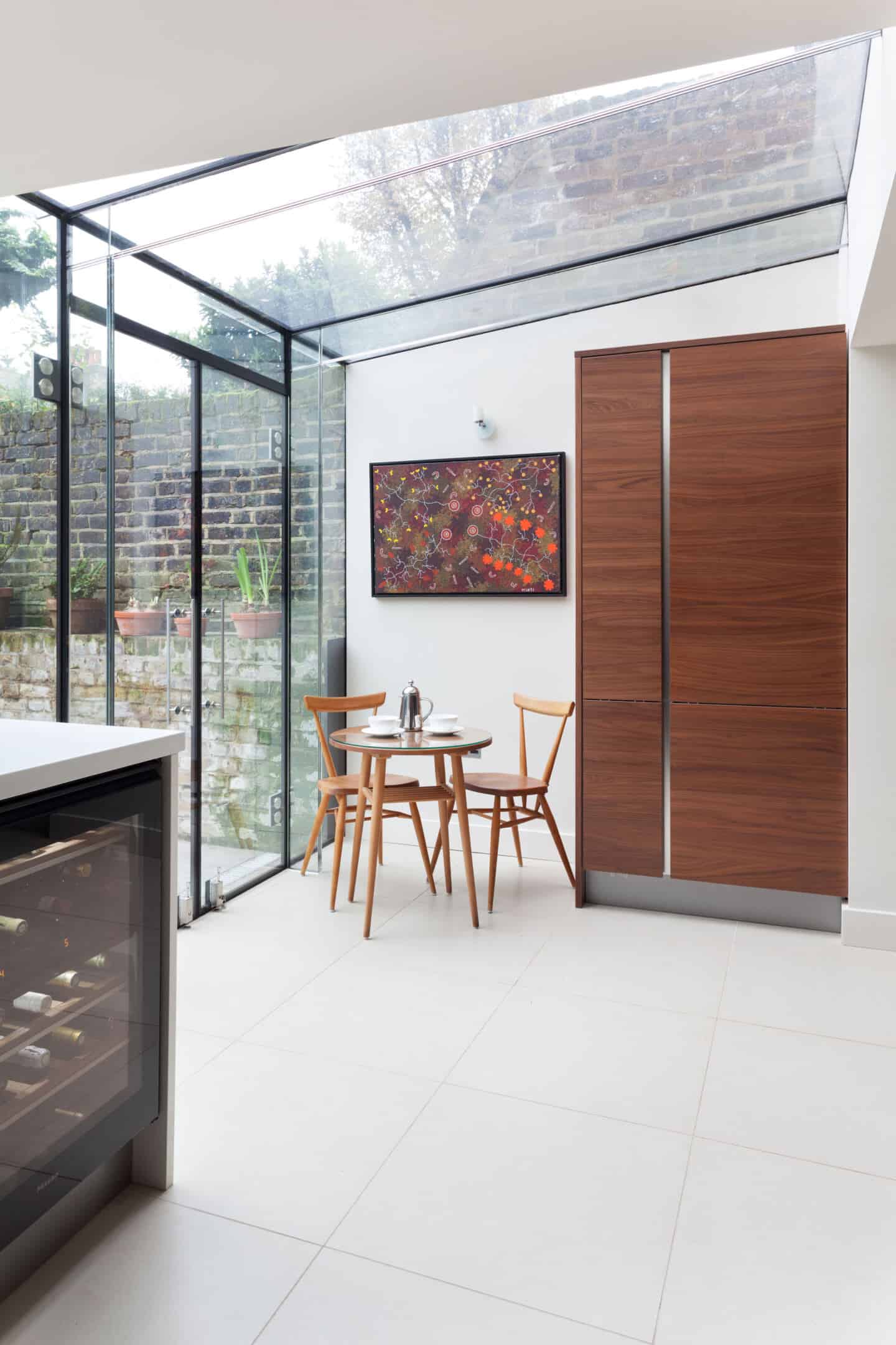 A glass box rear extension floods a kitchen with natural light