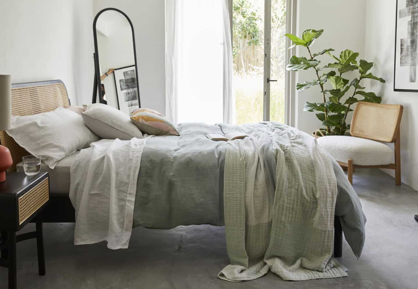 A Scandinavian style bedroom featuring natural materials and plants