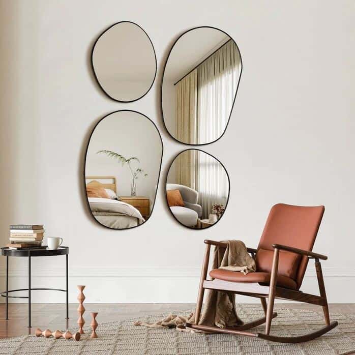 A collection of four wall-mounted organic shaped wall mirrors from Neutypechic above a rocking chair