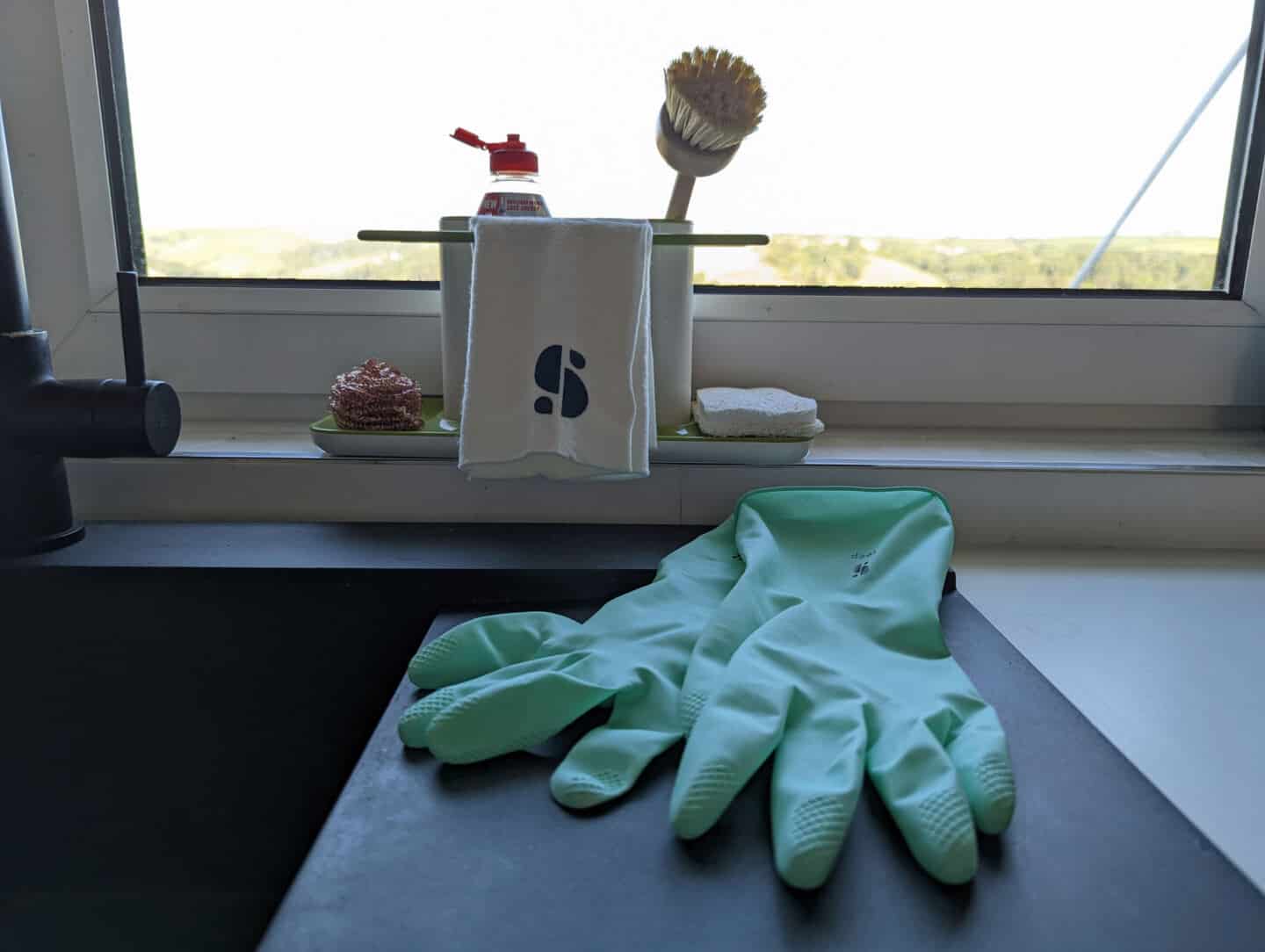 Eco-friendly, plastic-free cleaning products from Seep behind a sink, in front of a window