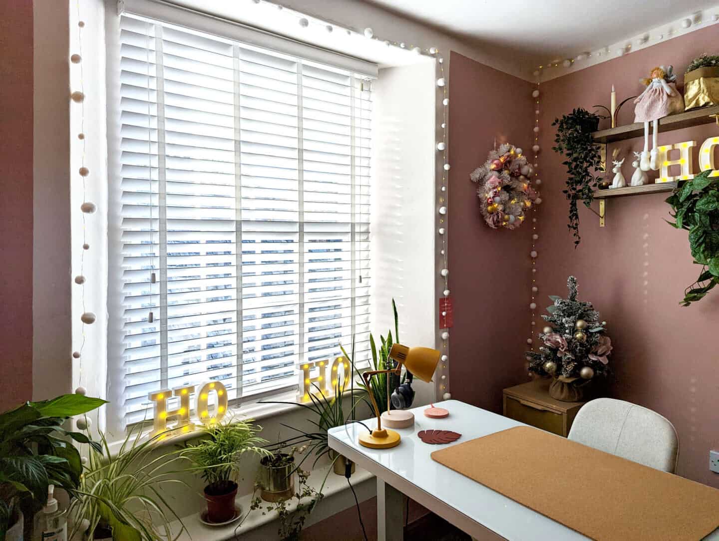 A pink home office decorated for Christmas