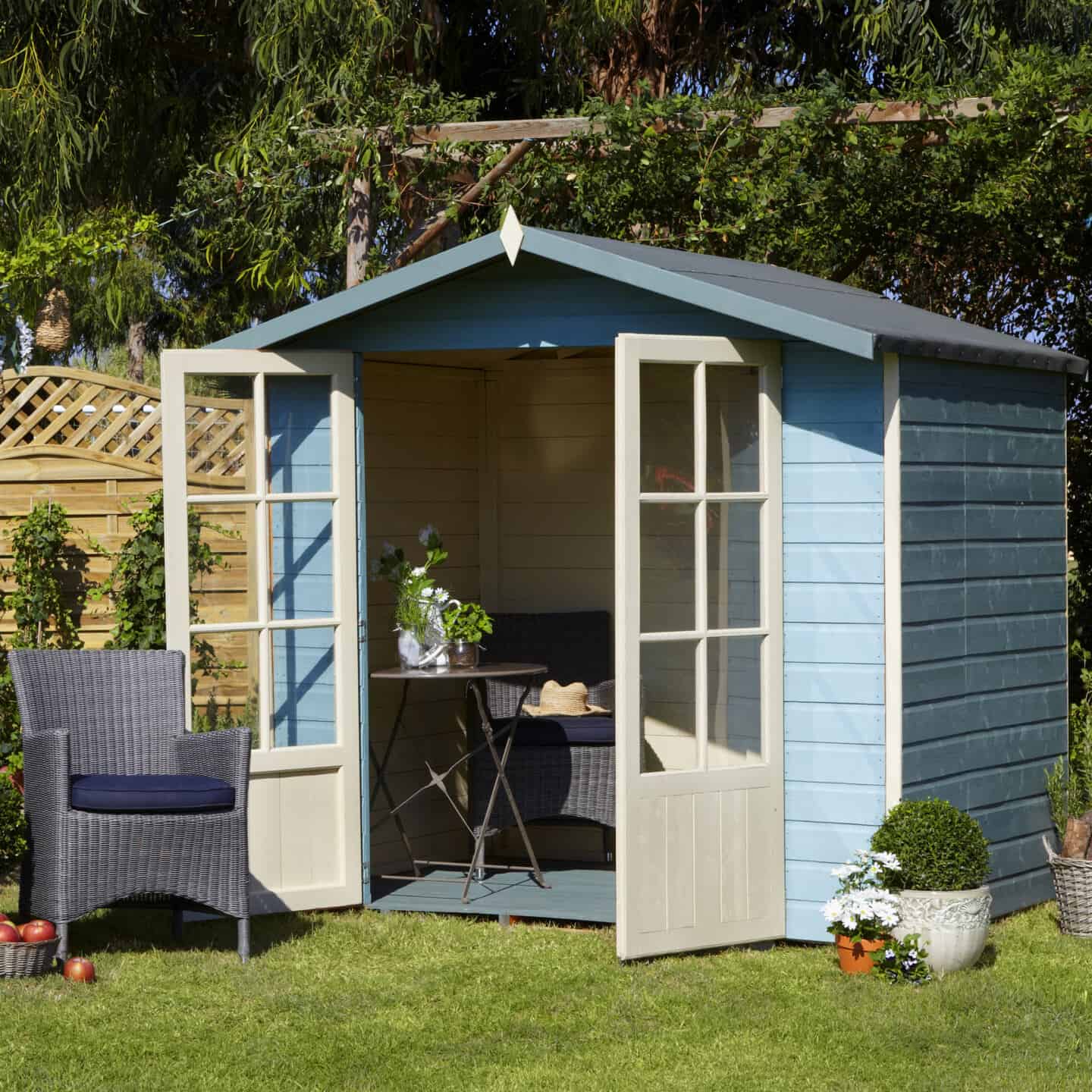 A garden shed painted blue and used as a summer house