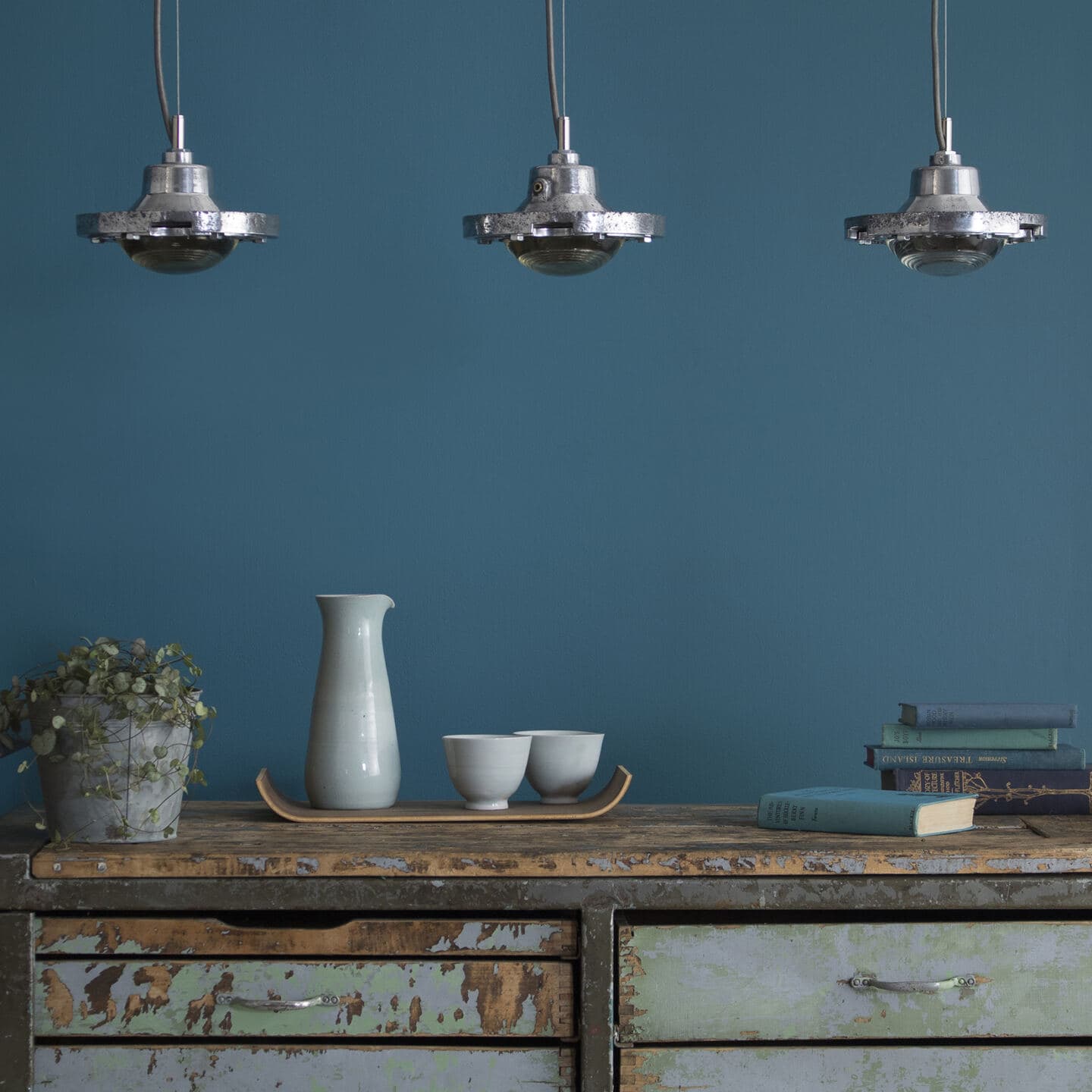 three salvaged lights hanging above a salvaged cabinet from Skinflint