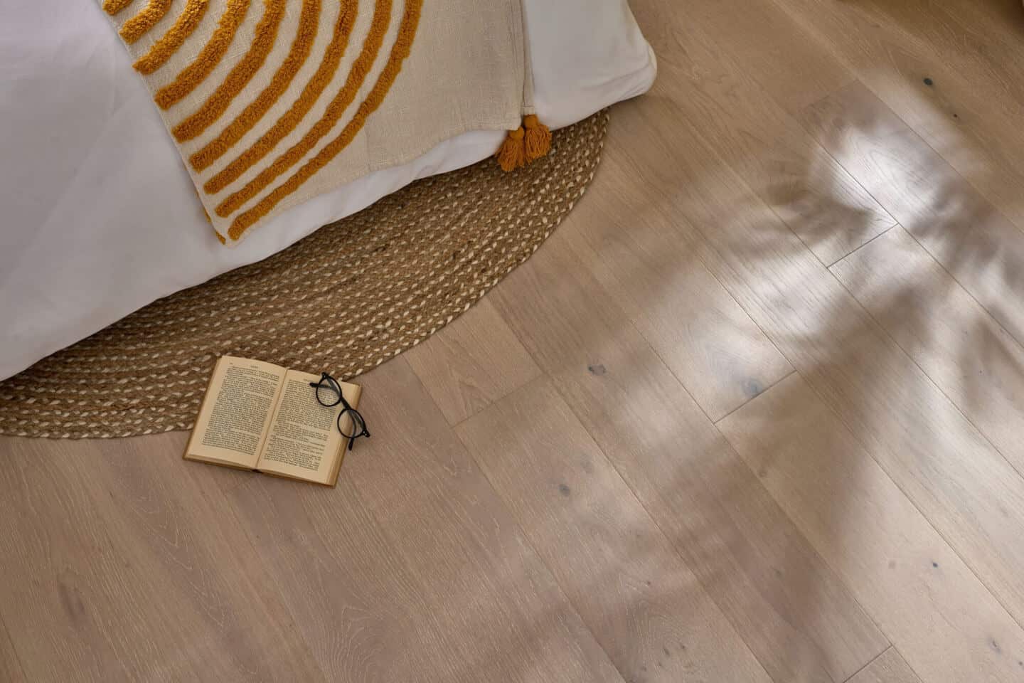 A close up of engineered oak flooring in a bedroom