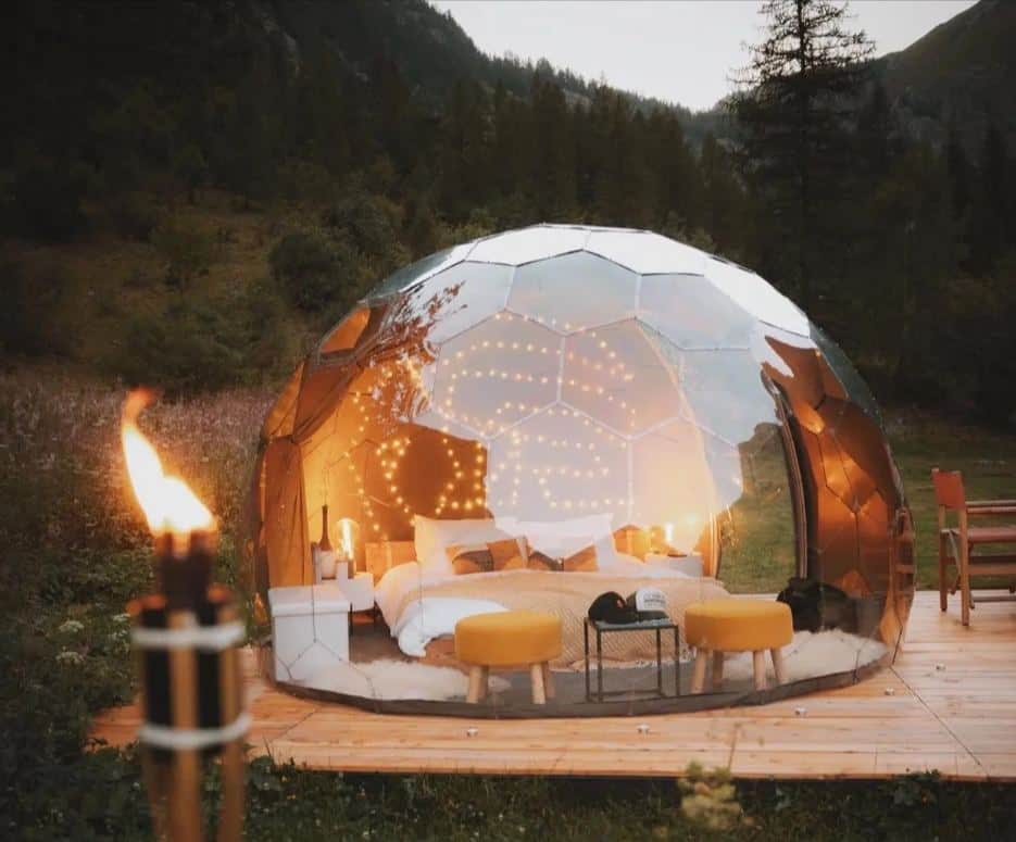 A bedroom is set up inside a garden dome