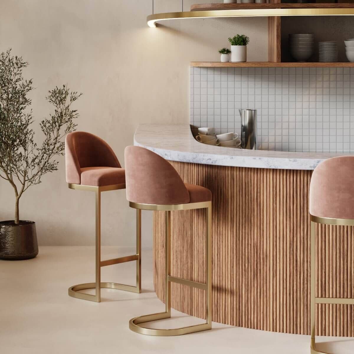 A wooden ribbed breakfast bar with marble counter top and pink velvet bar stools  