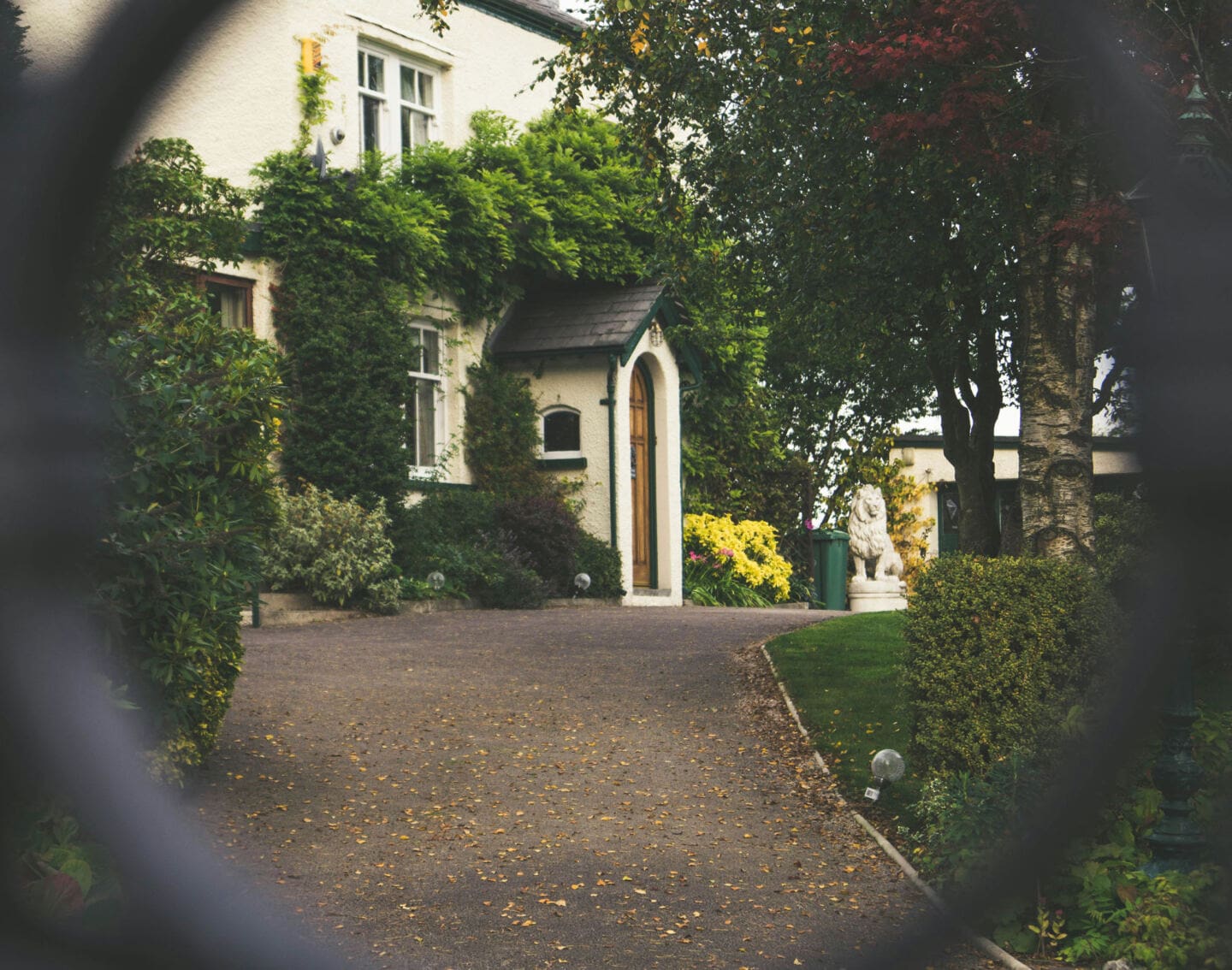 A white house at the end of a long driveway
