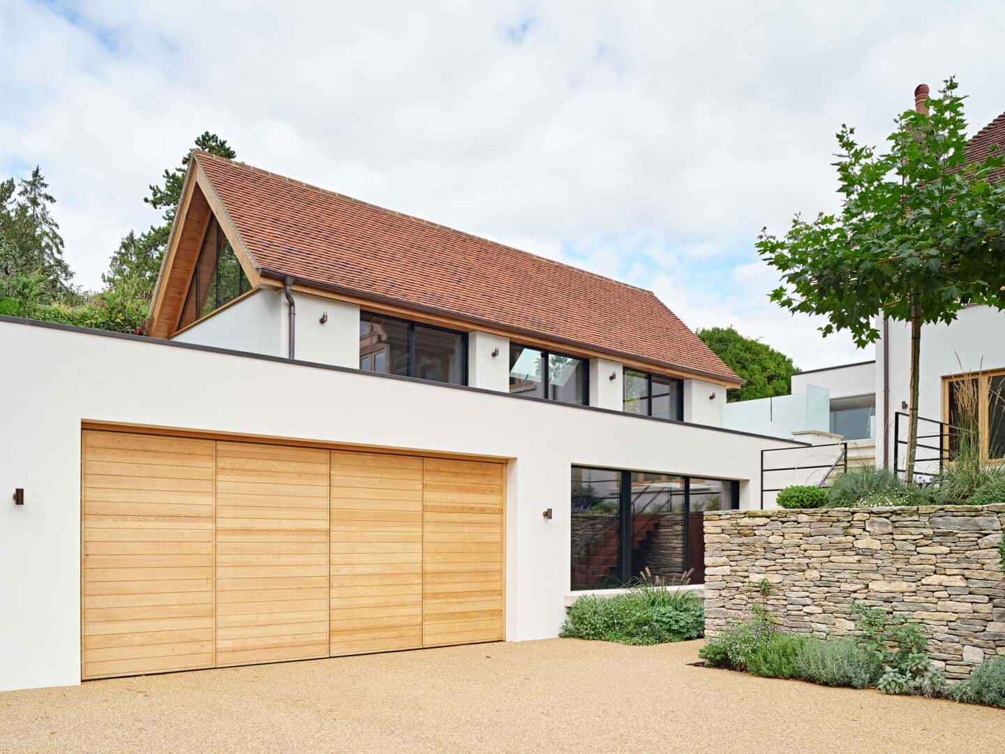 A modern house with integral garage that features double bi-fold doors in oak 